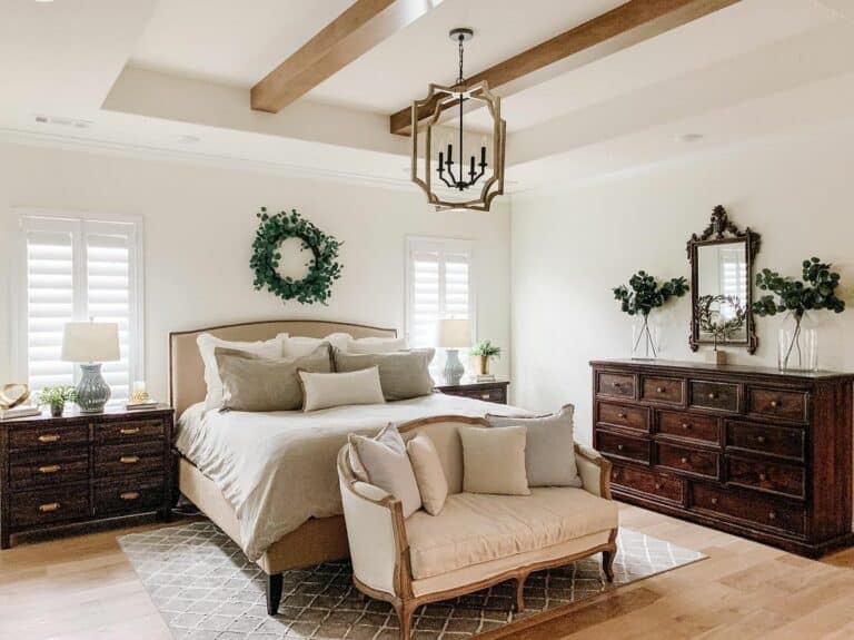 AGreen Wreath Above a Cushioned Beige Headboard