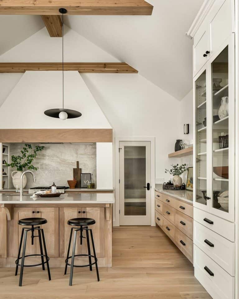 Black Barstools and a White Cabinet With Glass Doors