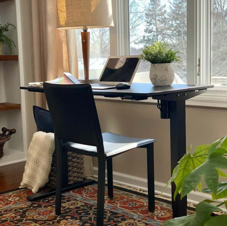 Black Desk Rests on Vibrant Patterned Rug
