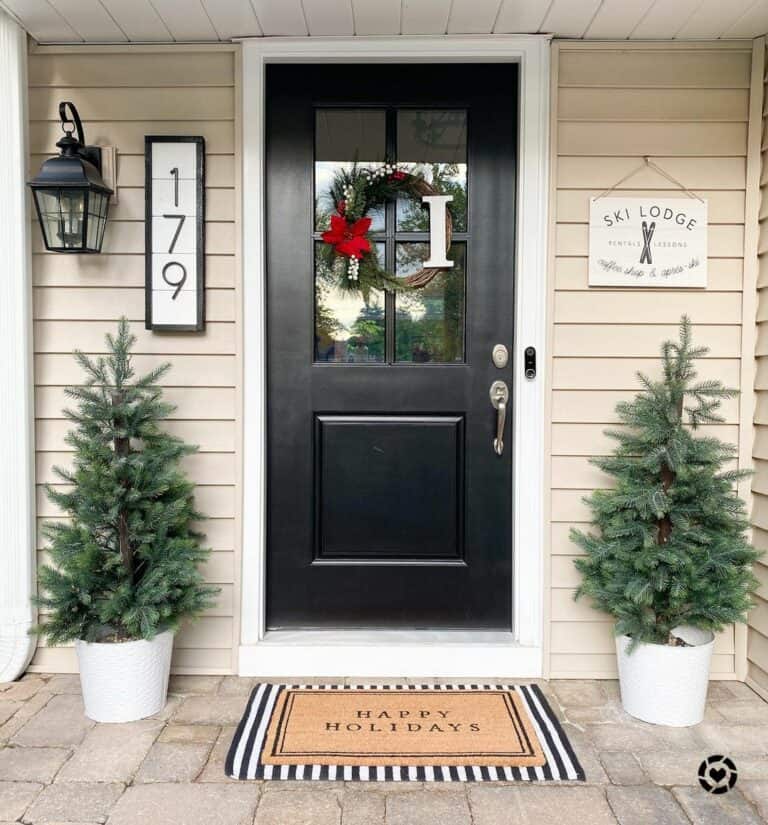 Black Entrance Door With Small Christmas Trees