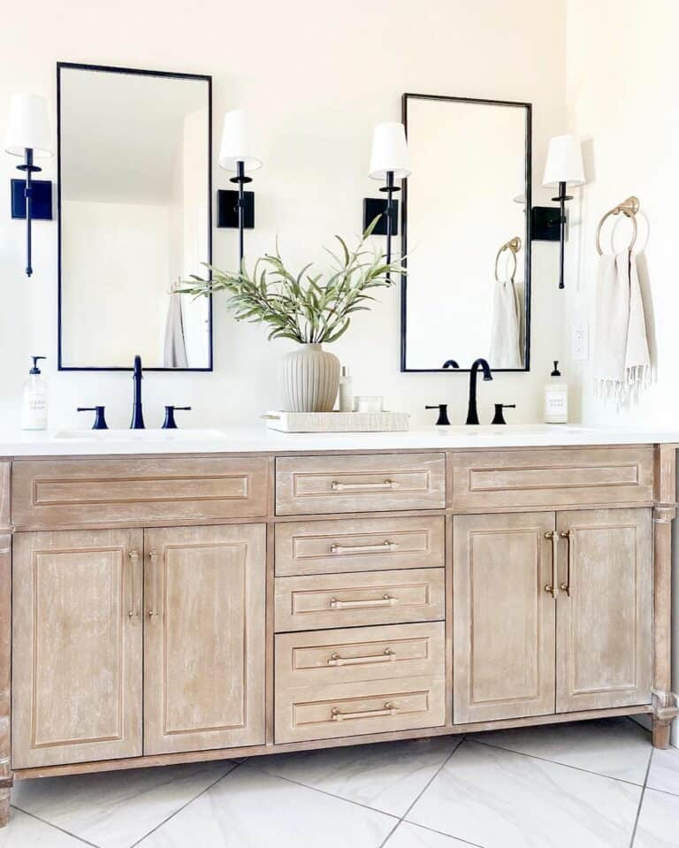 Black Torch Sconces Surround Rectangular Mirrors