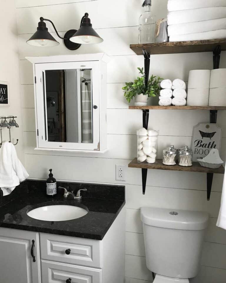 Black and White Bathroom With White Sink Cabinet