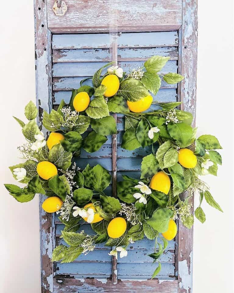 Bright Yellow Lemons and White Flowers on a Green Wreath