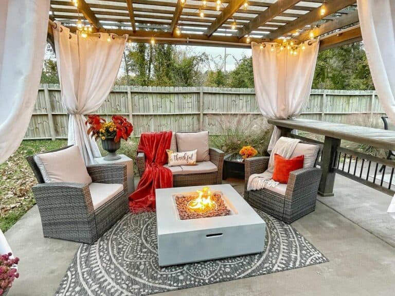 Cement Fire Pit and Seating Area in Cozy Pergola
