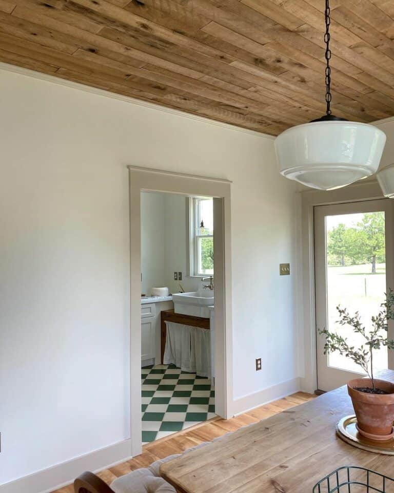 Dining Room With Wood Ceiling and Pendant Light