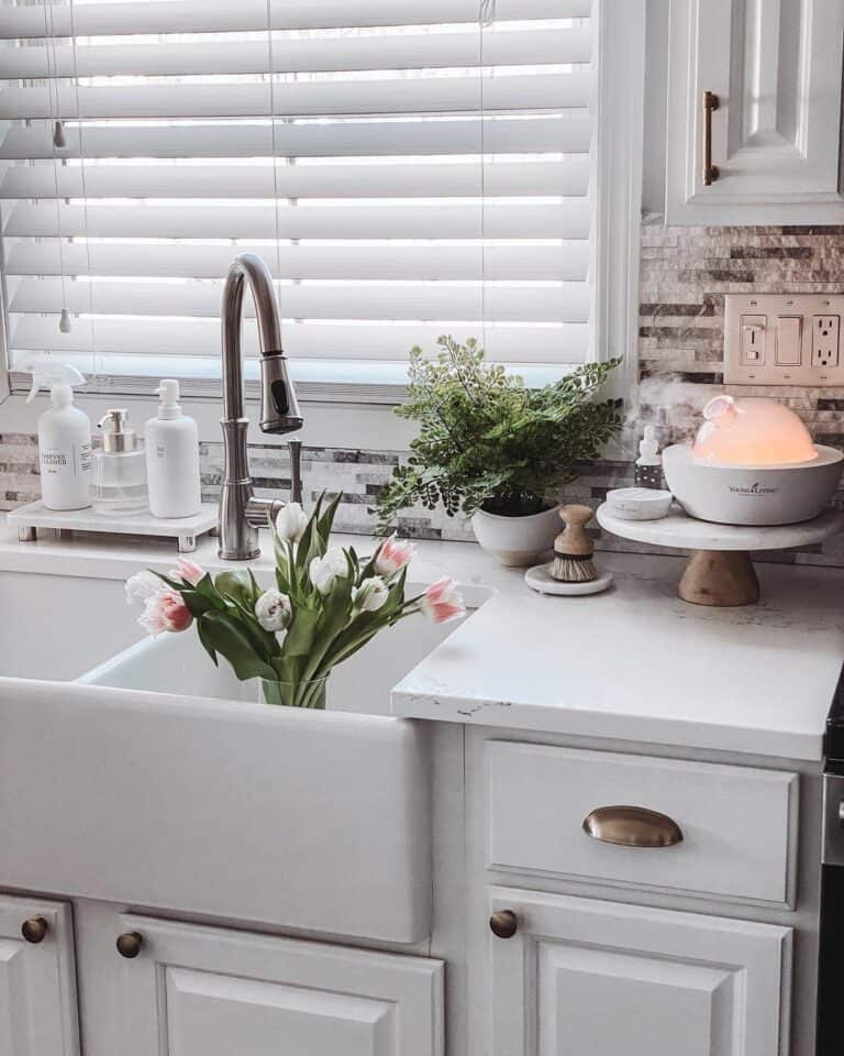 Farmhouse Sink Between White Kitchen Cabinets