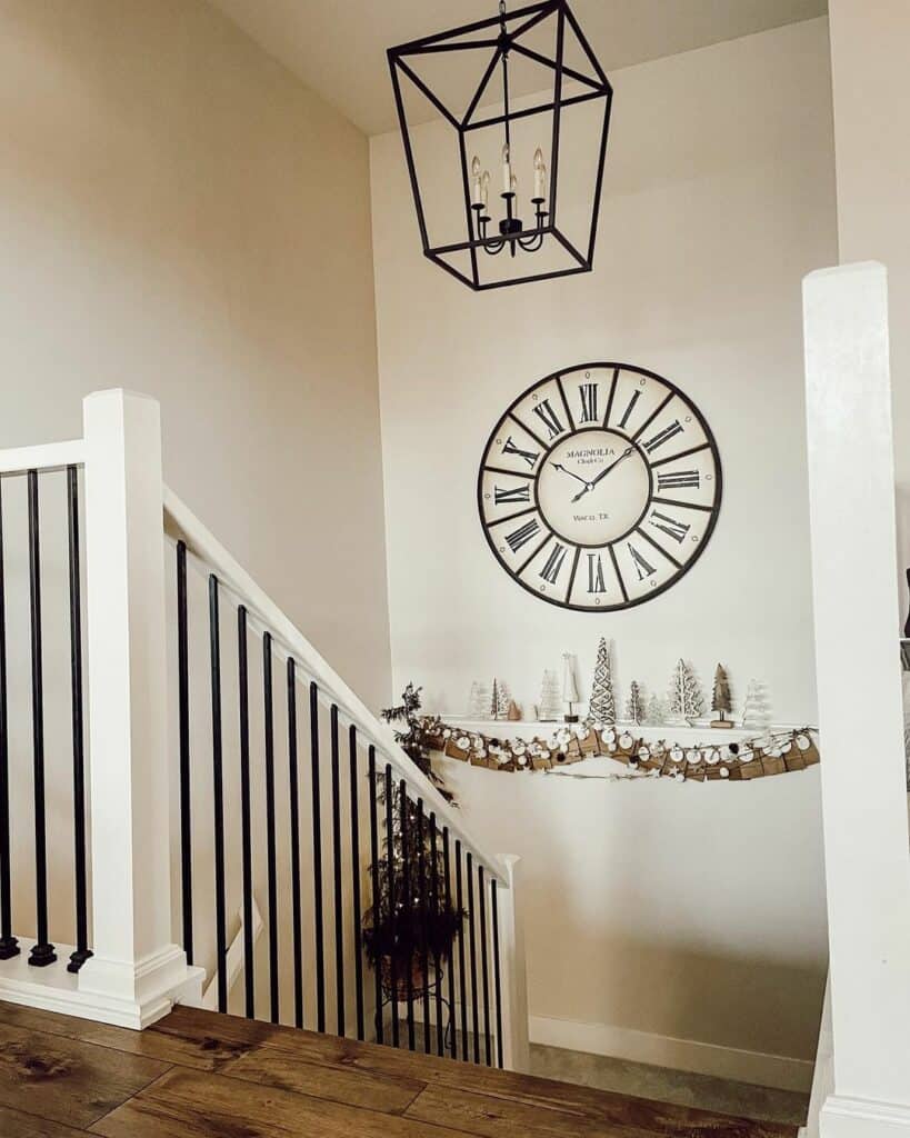 Farmhouse Staircase With Black Lantern Chandelier and Large Round Clock