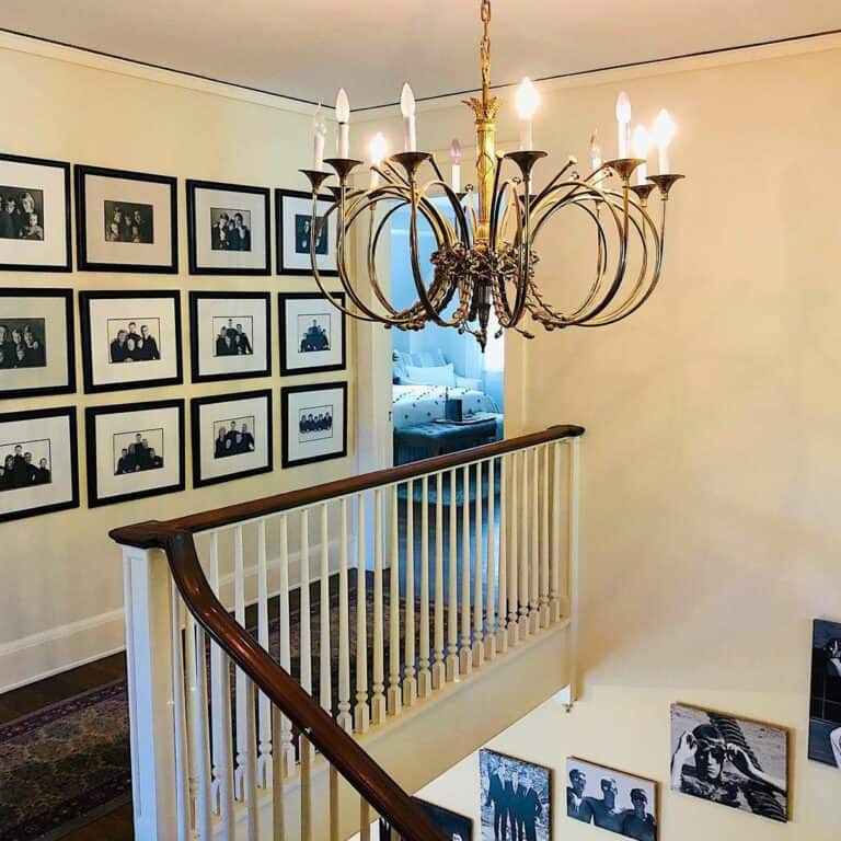 Farmhouse Staircase With Intricate Brass Chandelier