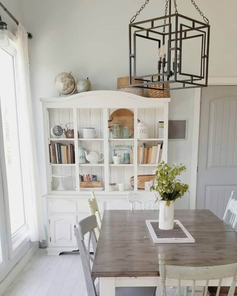 Farmhouse-style Dining Room With White Repurposed Cabinet