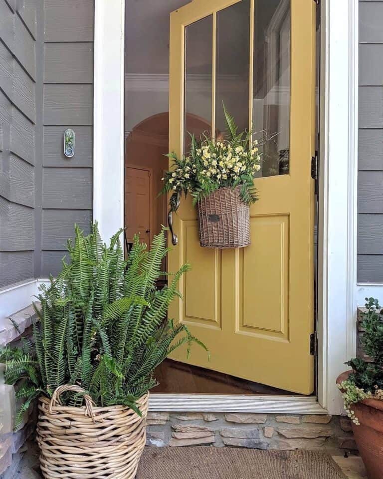 Front Door with Basket of Green Leaves and Yellow Flowers