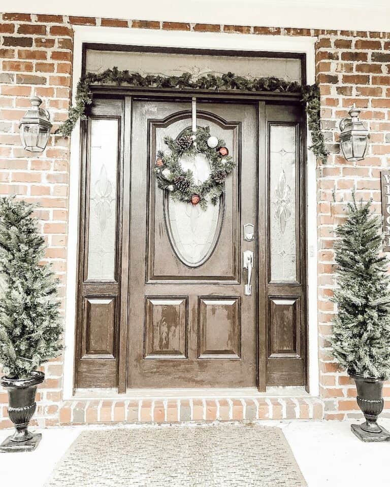 Front Entrance With Small Christmas Trees in Black Planters