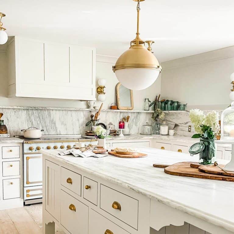 Gold and White Sphere Light Over a White Kitchen Island