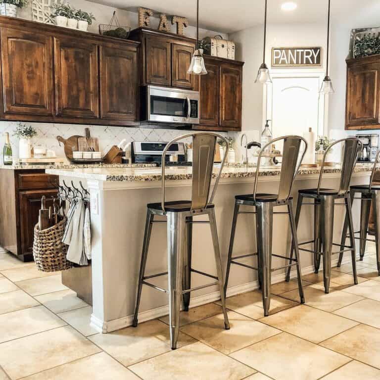 Gray Kitchen Island With Gray Metal Bar Chairs