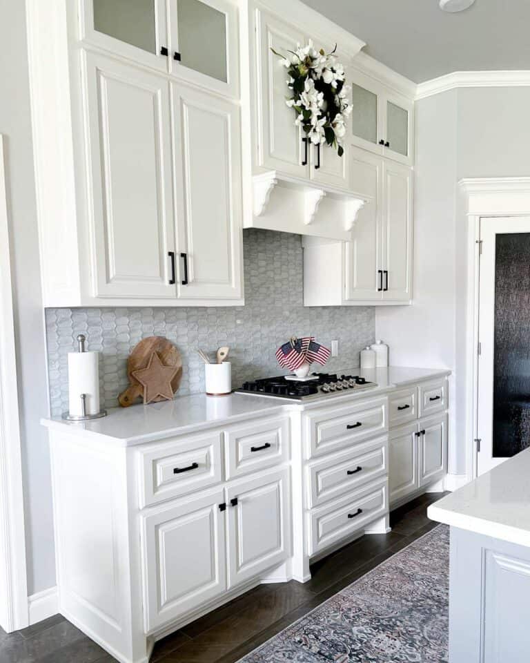 Gray Picket Tile Between White Cabinets
