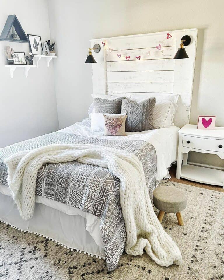 Gray and White Bed With Headboard Lamps