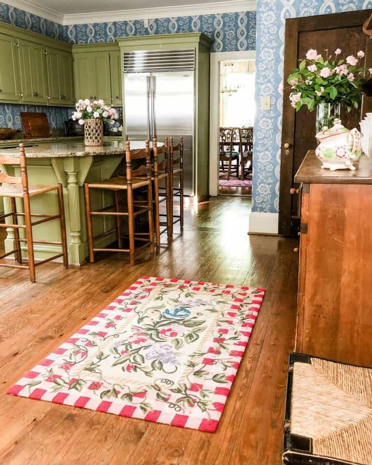 Green Eat-in Kitchen With Wooden Chairs