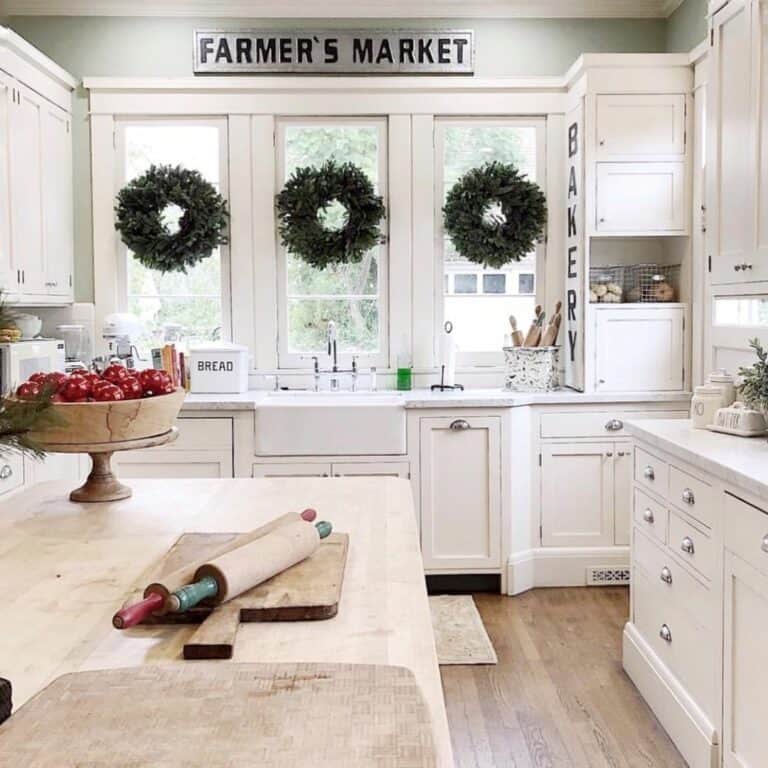 Green and White Farmhouse Kitchen With Wreaths on Windows