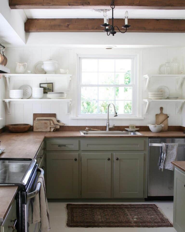 Kitchen With Green Cabinets and White Shelving