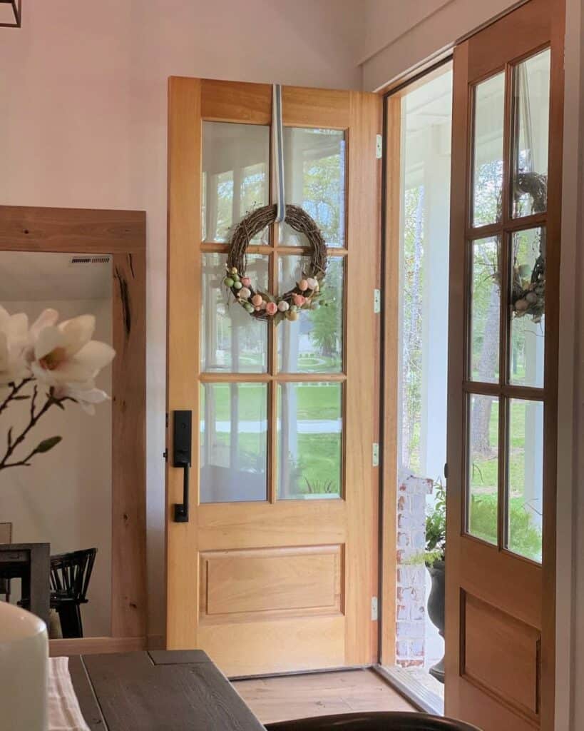 Light Wood Double Entrance Doors With Grapevine Wreaths