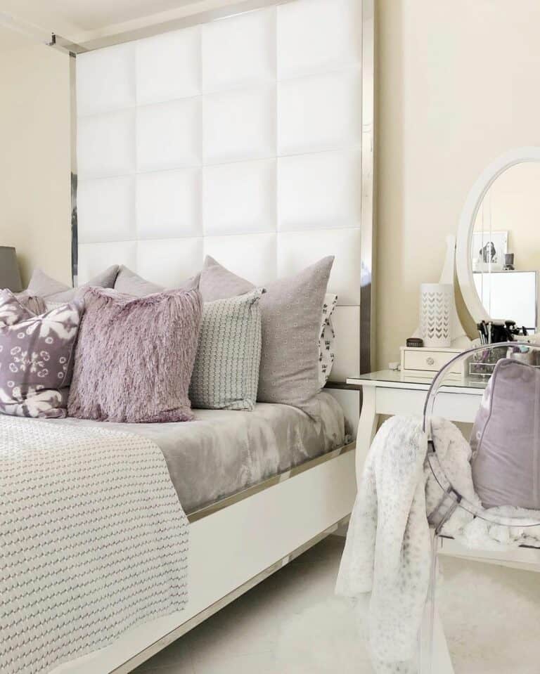 Lilac and Gray Bedding Beside Oval Mirror