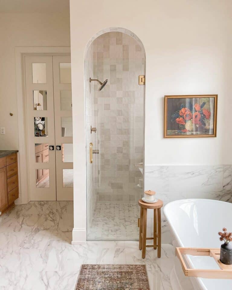 Marbled Bathroom With Arched Shower Entrance