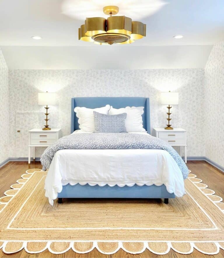 Modern Gold Chandelier Over a Bright Blue Bed