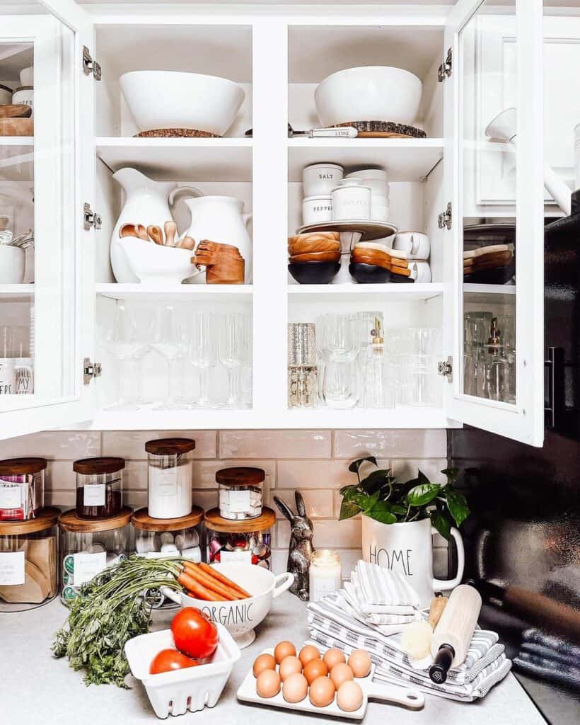 Open Glass Doors of a White Kitchen Cabinet