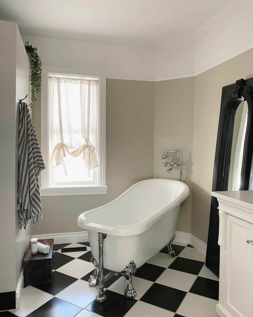 Retro-inspired Black and White Bathroom Flooring Idea With Antique Clawfoot Bathtub