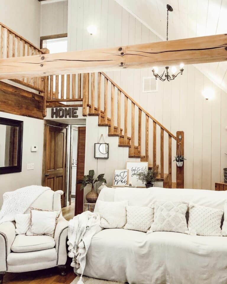 Shiplap Staircase With Large Black Chandelier