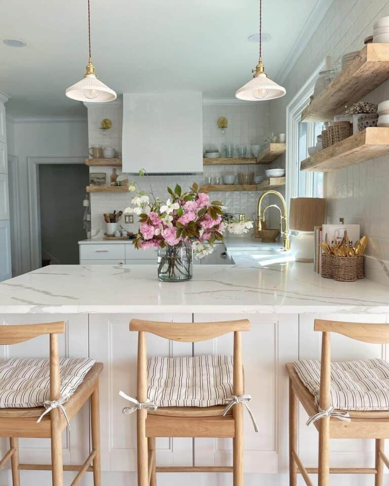 Small White Pendant Lights Over Marbled Countertop