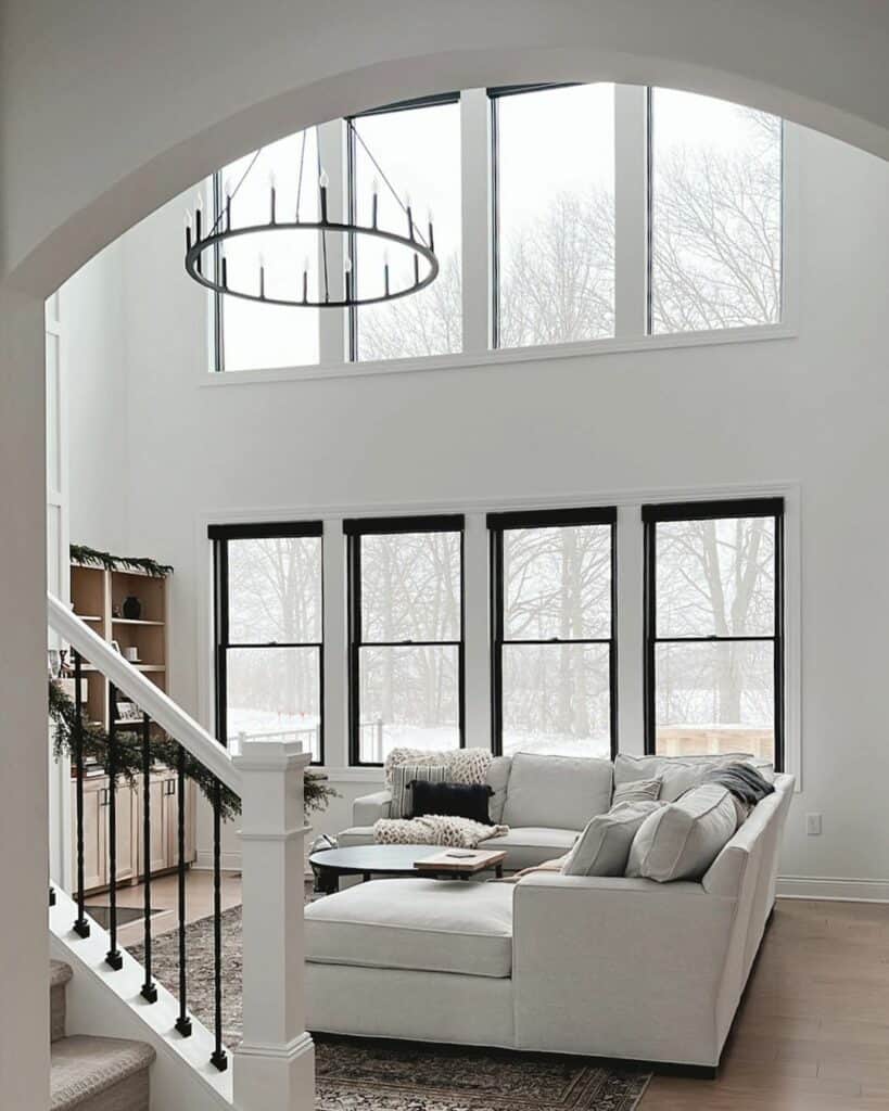 Spacious White Living Room With a Dark Round Chandelier