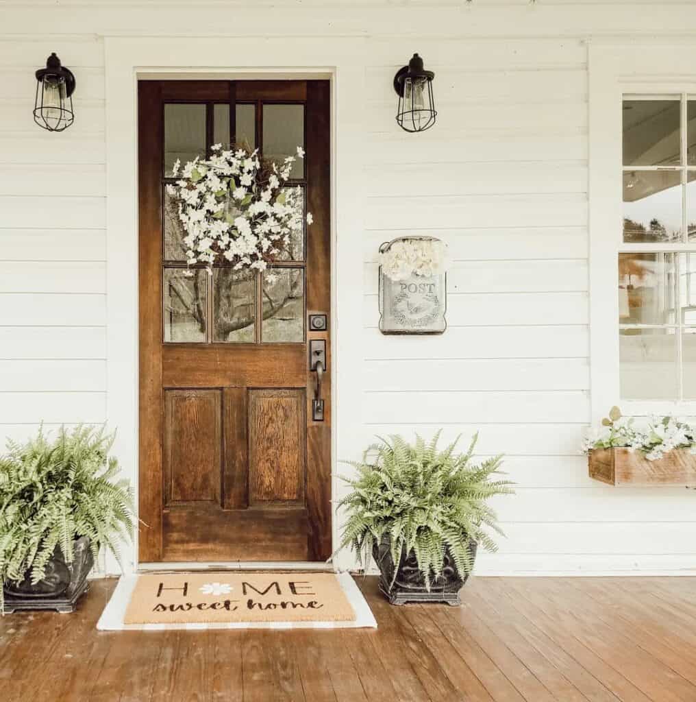 Stained Wood Door With White Floral Wreath