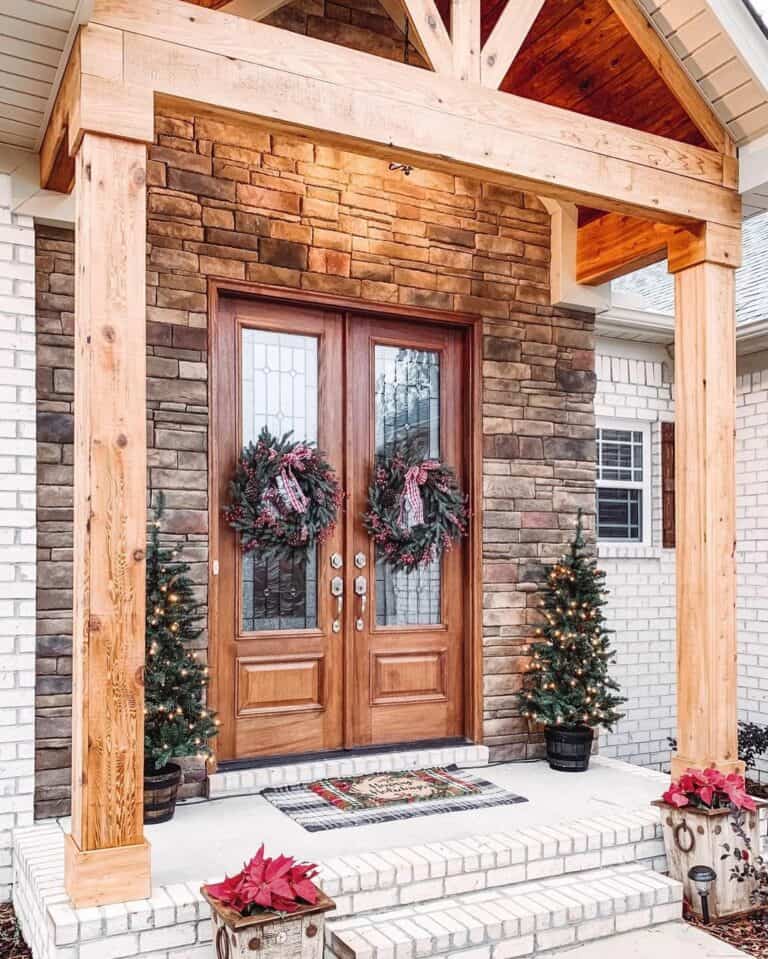 Stained Wood Double Front Doors With Christmas Wreaths