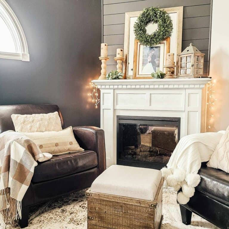 Two Cozy Brown Chairs in Front of a White Fireplace