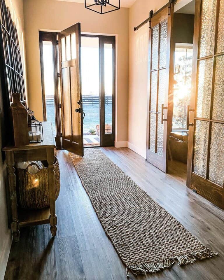 Warm Entryway With Double Dark Brown Barn Door With Glass