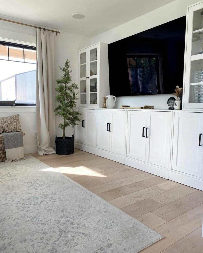 White Cabinets With Glass Doors and a Small Pine Tree