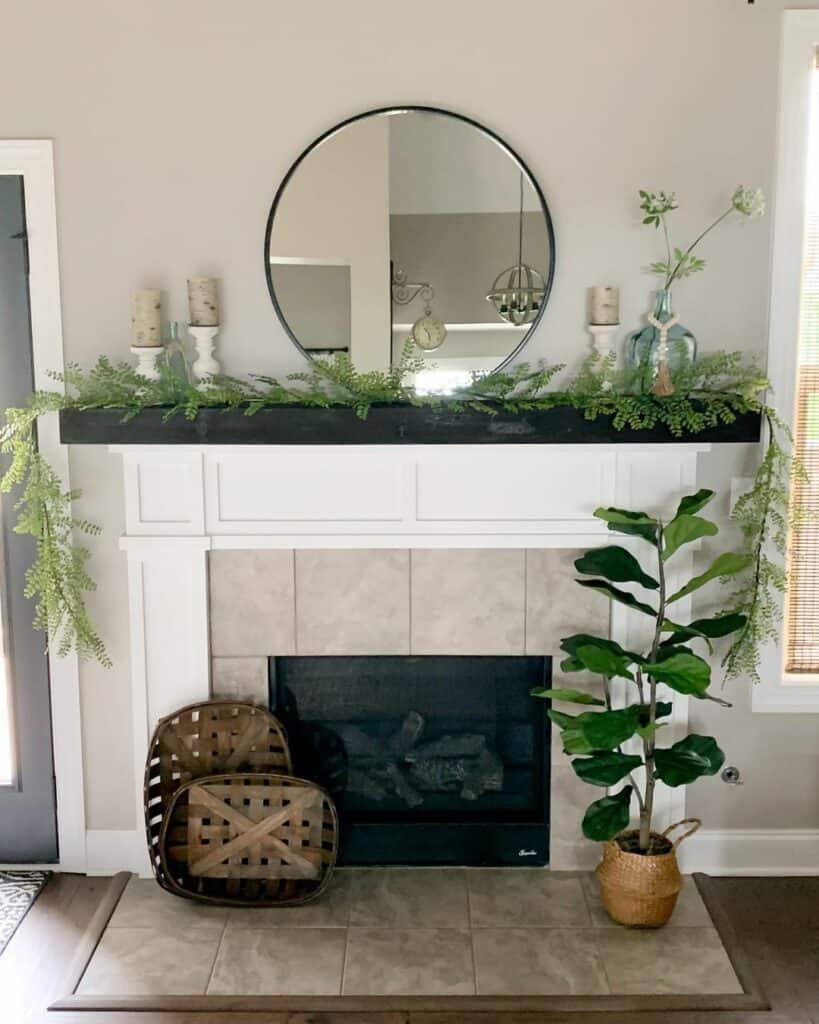 White Candlesticks Behind a Bright Green Garland