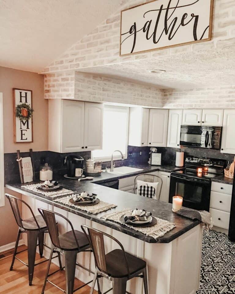 White Kitchen Peninsula With Gray Metal Chairs