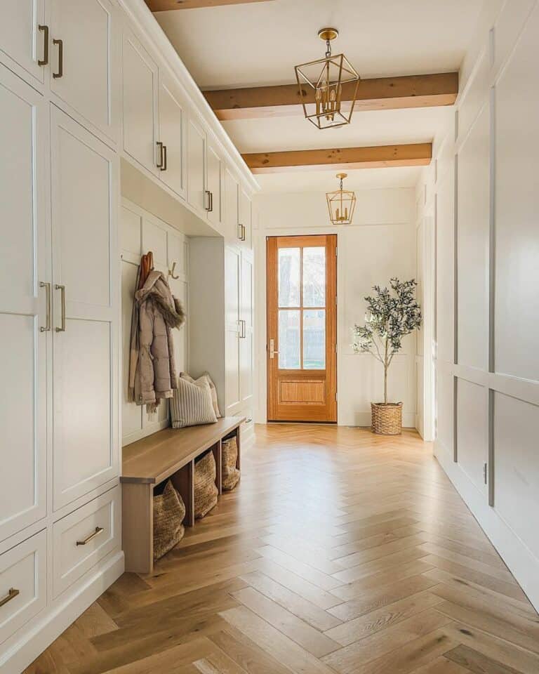 White Lockers and Herringbone Wood Floors in Minimalist Mudroom