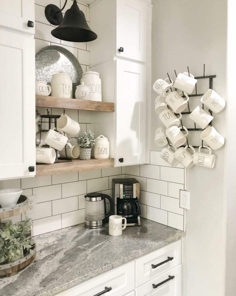 White Mugs Above a Stainless Steel Coffee Maker