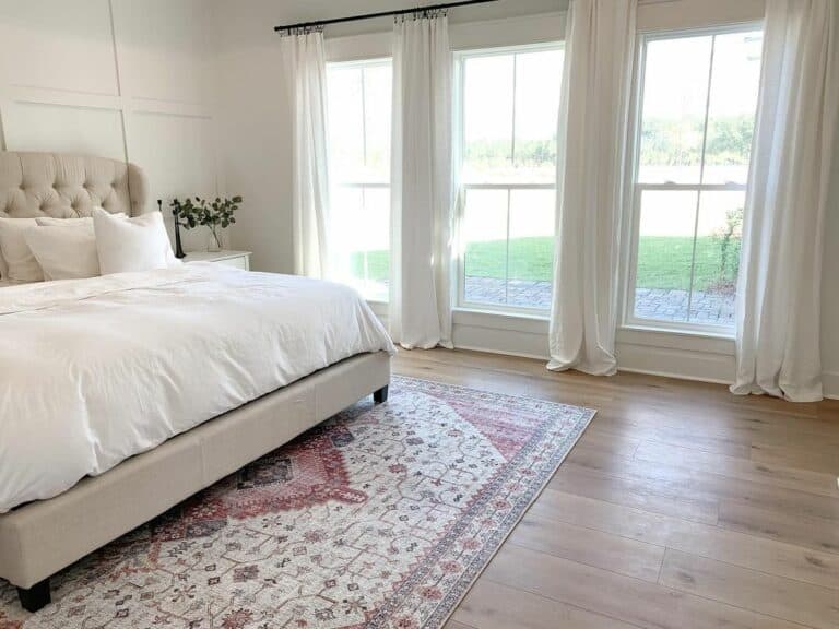 White Paneled Wall Bedroom with Windows