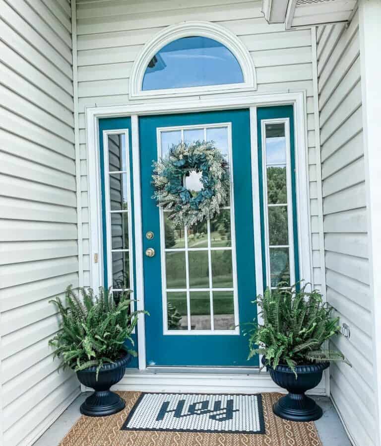 White Siding Surrounds a Blue Front Door