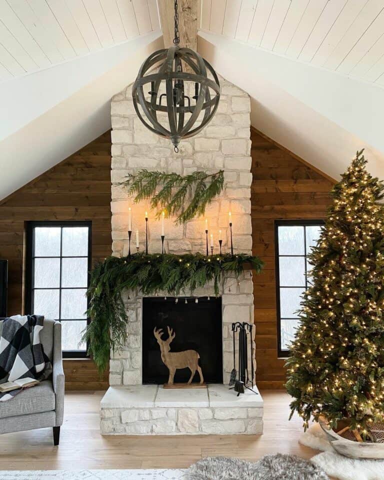 White Stone Fireplace With Wood Reindeer Décor