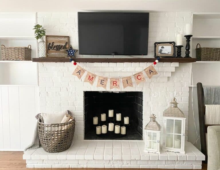 White-painted Brick Fireplace With 4th of July Garland
