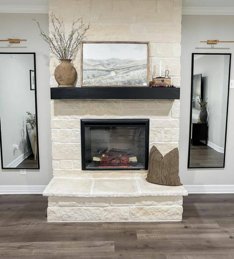 White-stone Fireplace With a Black Mantel