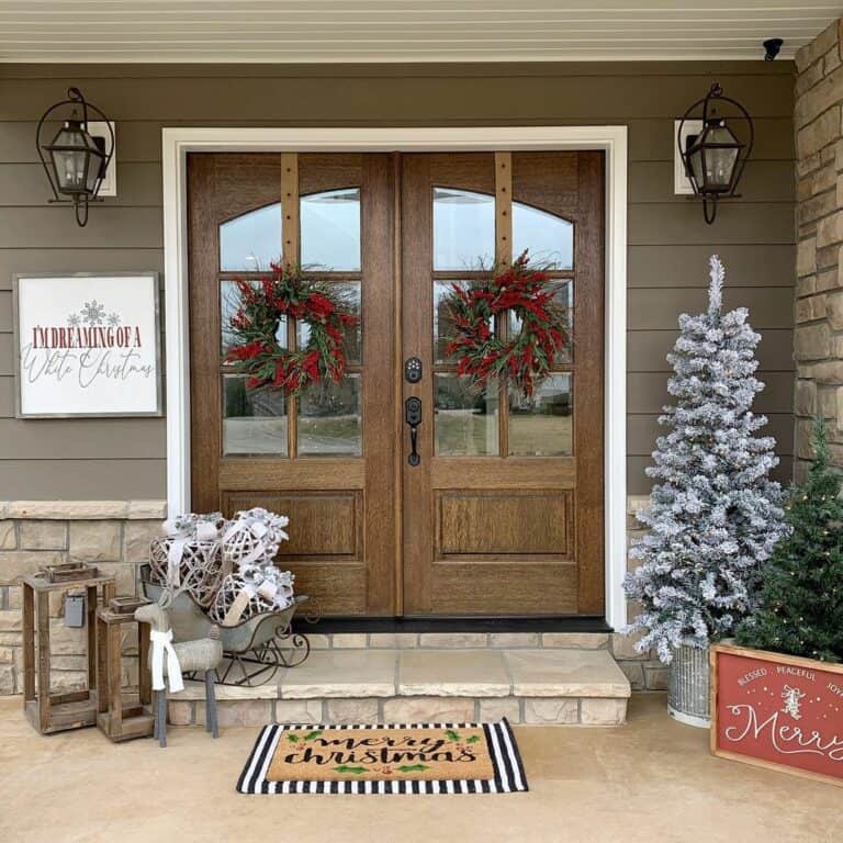 Wood Double Doors With Red Berry Wreaths