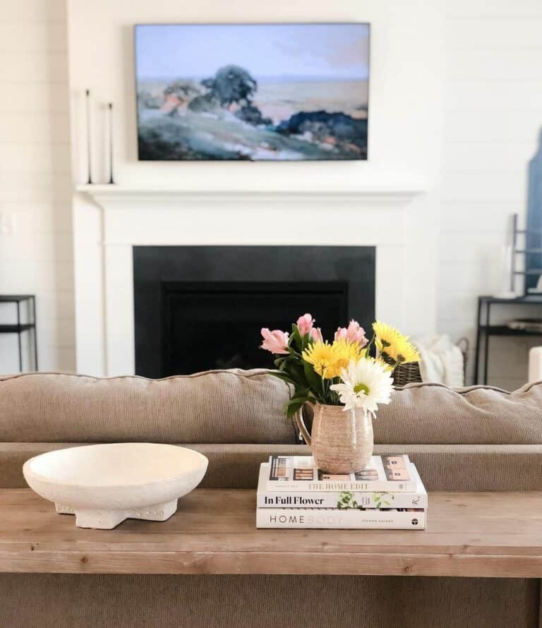 Wood Sofa Table With Floral Décor on Book Stack
