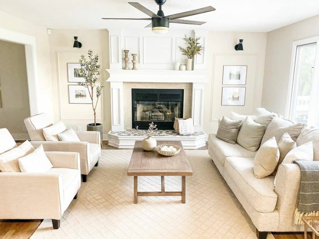 Wooden Candlesticks and Green Branches on a White Mantel