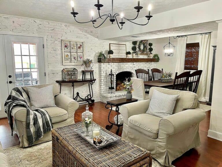 A Black Chandelier and Comfortable White Armchairs