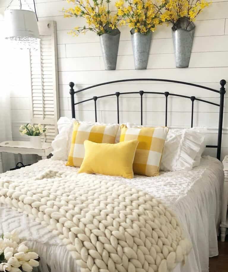 Bedroom With Vibrant Yellow Cushions and Flowers